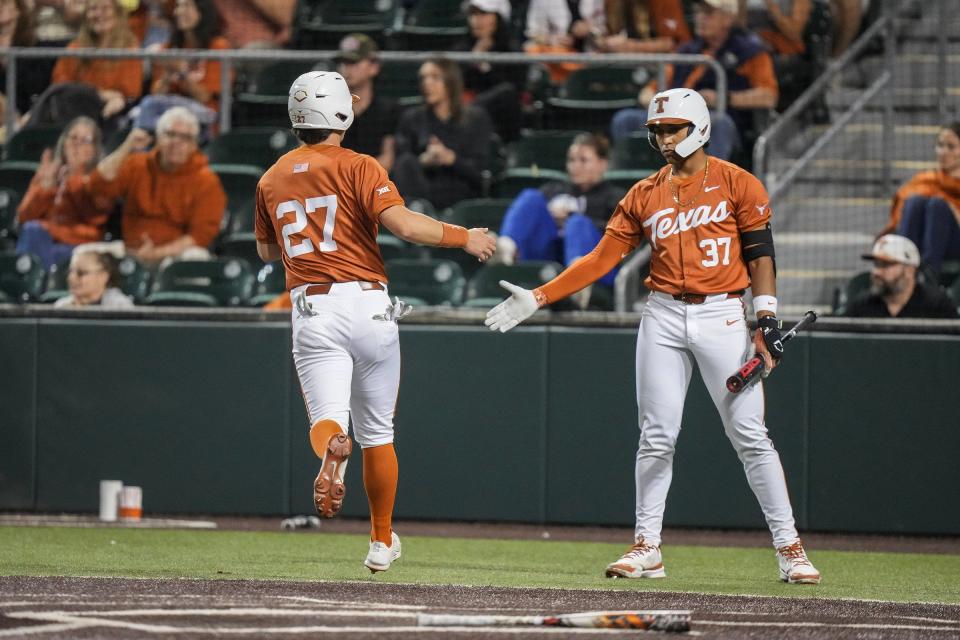 Texas infielder Jack O'Dowd, left, high-fives catcher Nik Sanders after crossing home plate in Tuesday's 20-3 win over Houston Christian. The 16th-ranked Longhorns improved to 3-1.