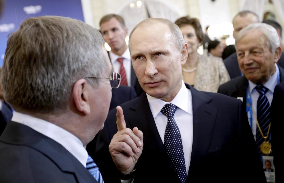 Russian President Vladimir Putin, right, talks with International Olympic Committee President Thomas Bach, at a welcoming event for IOC members ahead of the upcoming 2014 Winter Olympics at the Rus Hotel, Tuesday, Feb. 4, 2014, in Sochi, Russia. (AP Photo/David Goldman, Pool)