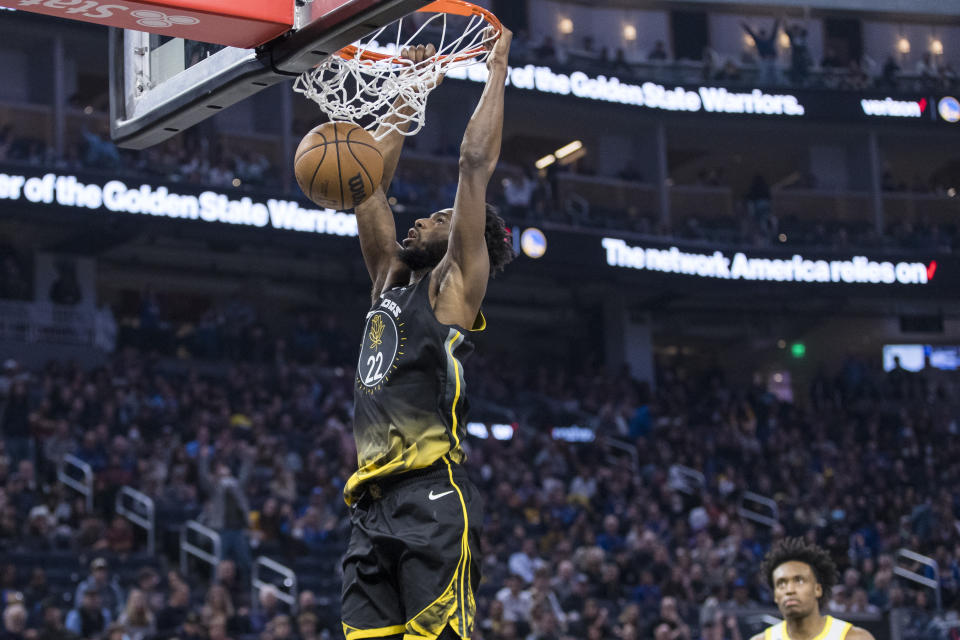 Golden State Warriors forward Andrew Wiggins (22) dunks against the Utah Jazz during the first half of an NBA basketball game in San Francisco, Friday, Nov. 25, 2022. (AP Photo/John Hefti)