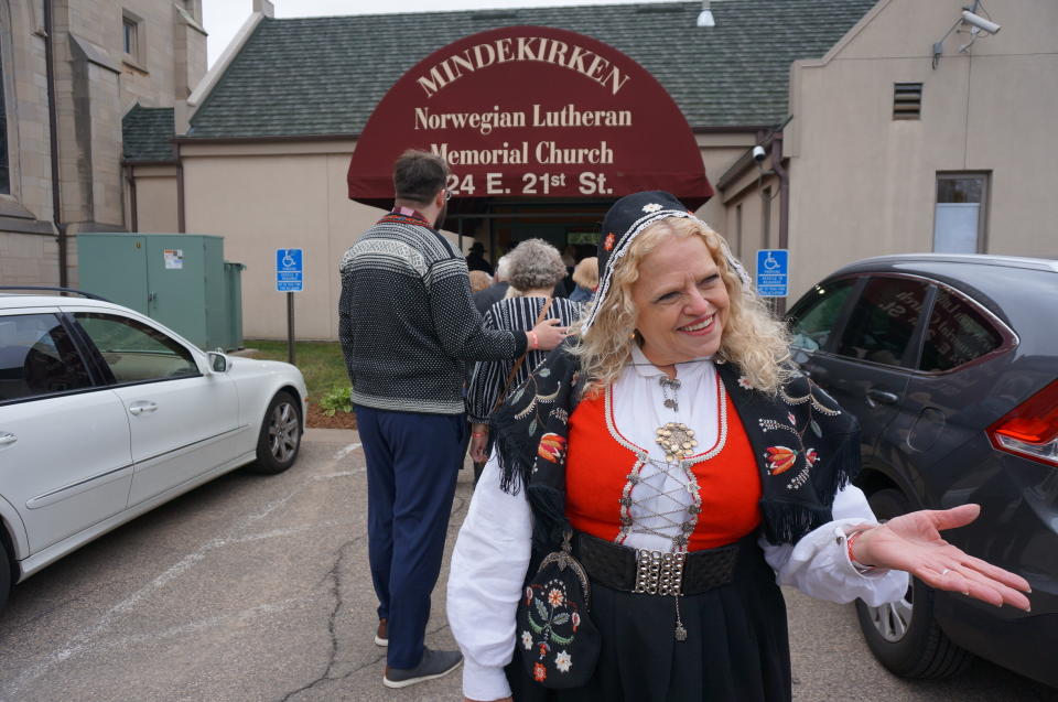 People are welcomed as they line up to be allowed into church before the arrival of Queen Sonja of Norway at the podium at Den Norske Lutherske Mindekirke, the Norwegian Lutheran Memorial Church in Minneapolis, Sunday Oct. 16, 2022. (AP Photo/Giovanna Dell'Orto)