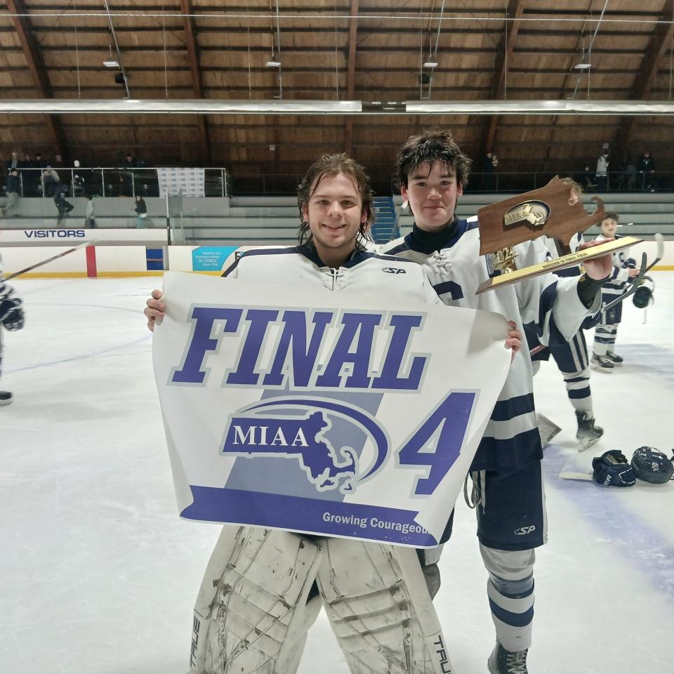 Somerset Berkley goalie Brandon Silva holds up the Final 4 Banner and teammate Kein Stafford hold up the trophy after the Raiders blanked West Springfield, 3-0, in the Division 3 Elite game at Loring Arena in Framingham.