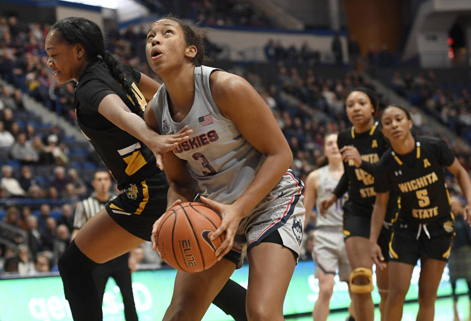 Connecticut's Megan Walker looks to shoot as Wichita State's Shyia Smith, left, defends during the second half of an NCAA college basketball game Thursday, Jan. 2, 2020, in Hartford, Conn. (AP Photo/Jessica Hill)