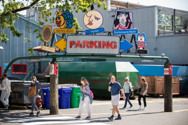 Pedestrians walk on Granville Island in Vancouver, British Columbia on Friday, May 31, 2019. (Ben Nelms/CBC - image credit)