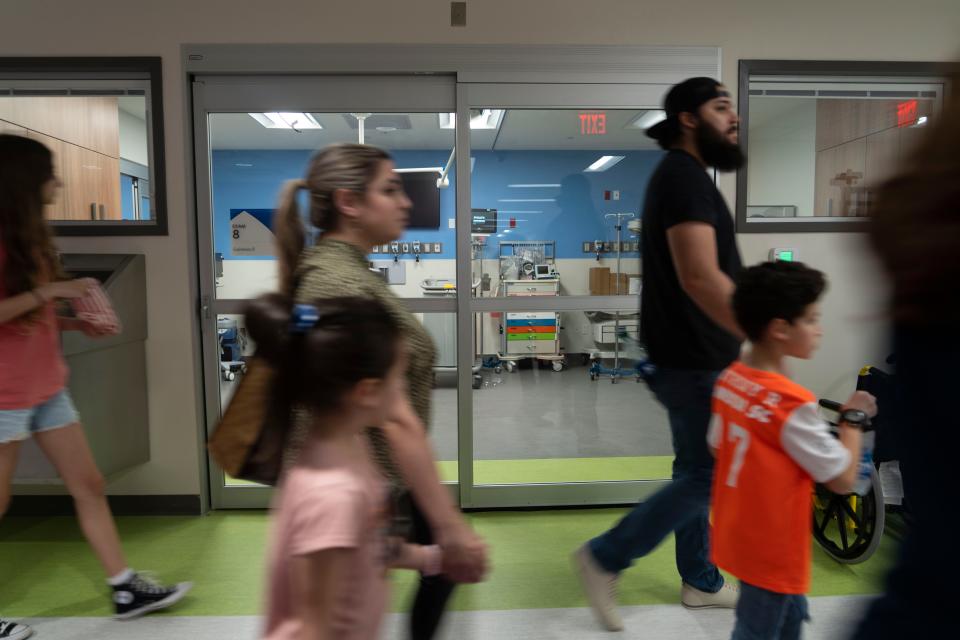 Visitors tour the first floor of the facility, where the emergency department has 18 rooms and is expected to see 45 to 50 children a day.