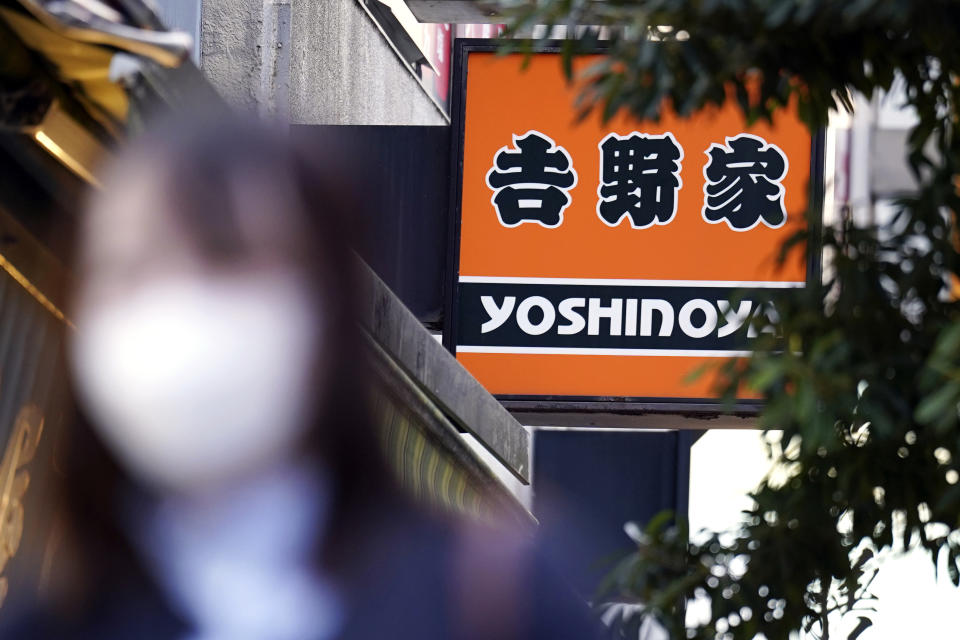 A signboard of a Yoshinoya restaurant, a fast food beef bowl chain, is seen Wednesday, April 5, 2023, in Tokyo. Japanese police have arrested two men on suspicion of shoveling ginger condiment into his mouth directly from a communal container with his chopsticks at a famous beef bowl restaurant in western Japan, a latest in the series of food pranks that had earlier hit sushi chains and known as “sushi terrorism.” (AP Photo/Eugene Hoshiko)