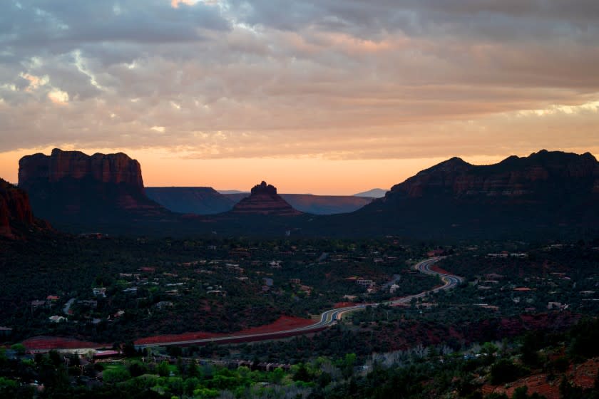 Overcast skies are seen over Sedona as the sunsets over the Verde Valley region, as people watch the sunset from atop of the summit of the Airport Mesa Loop Trail on Monday, April 20, 2020 in Sedona, AZ. In early April, in an attempt to slow the spread of the coronavirus pandemic, Arizona Governor Doug Ducey issued an Executive Order emphasizing enhanced physical distance and encouraging Arizonans to stay at home – an order, that is in effect until April 30.