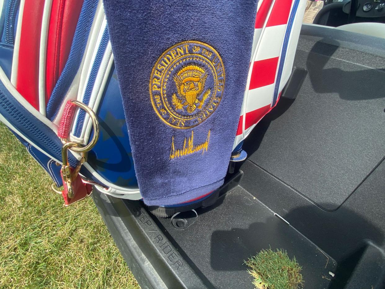 Trump's golf towel stamped with the presidential logo.