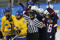 Emilia Anderson of Sweden and Johanna Olofsson of Sweden react after a goal by team USA during the first period of the 2014 Winter Olympics women's semifinal ice hockey game at Shayba Arena Monday, Feb. 17, 2014, in Sochi, Russia. (AP Photo/Julio Cortez)