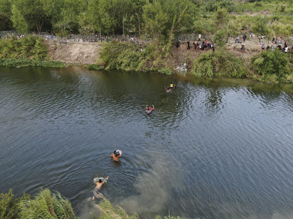 Migrants cross the Rio Grande river from Matamoros, Mexico, Wednesday, May 10, 2023. The U.S. on May 11 will begin denying asylum to migrants who show up at the U.S.-Mexico border without first applying online or seeking protection in a country they passed through, according to a new rule released on May 10. (AP Photo/Fernando Llano)