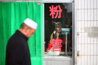 A woman prepares food at a shop in China's Linxia, Gansu province, home to a large population of ethnic minority Hui Muslims, February 3, 2018. Picture taken February 3, 2018. REUTERS/Michael Martina