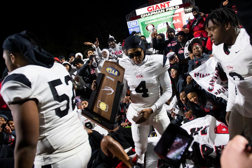 Aliquippa football team members gather together for a group photo following the PIAA Class 4A football championship game against Dallas at Cumberland Valley High School, Thursday, Dec. 7, 2023, in Mechanicsburg, Pa. The Quips won their fifth state title, 60-14.