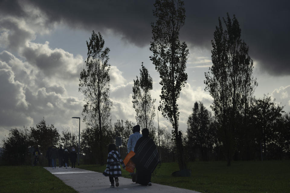 Migrants leave the reception center to go for a walk in Ter Apel, north eastern Netherlands, Thursday, Nov. 9, 2023. (AP Photo/Peter Dejong)