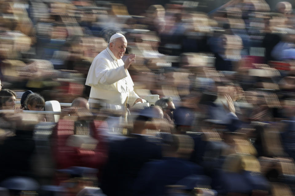 Pope Francis waves to faithful as he arrives for his weekly general audience, in St. Peter's Square, at the Vatican, Wednesday, Nov. 27, 2019. (AP Photo/Andrew Medichini)