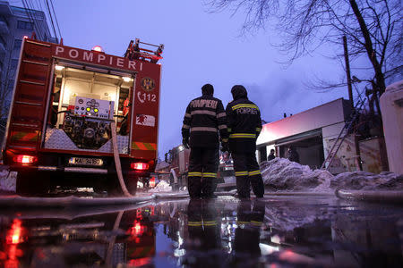 Romanian firefighters work at the scene of a fire that destroyed a night club in Bucharest, Romania, January 21, 2017. Inquam Photos/Octav Ganea/via REUTERS