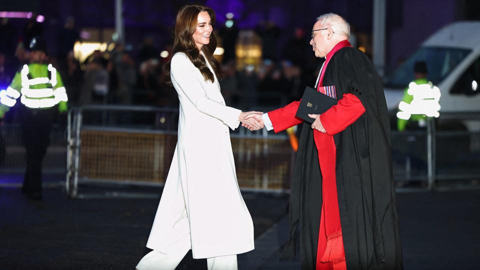 Britain's Catherine, Princess of Wales is greeted by The Dean of Westminster, David Hoyle as she arrives to attend the "Together At Christmas" Carol Service" at Westminster Abbey in London o