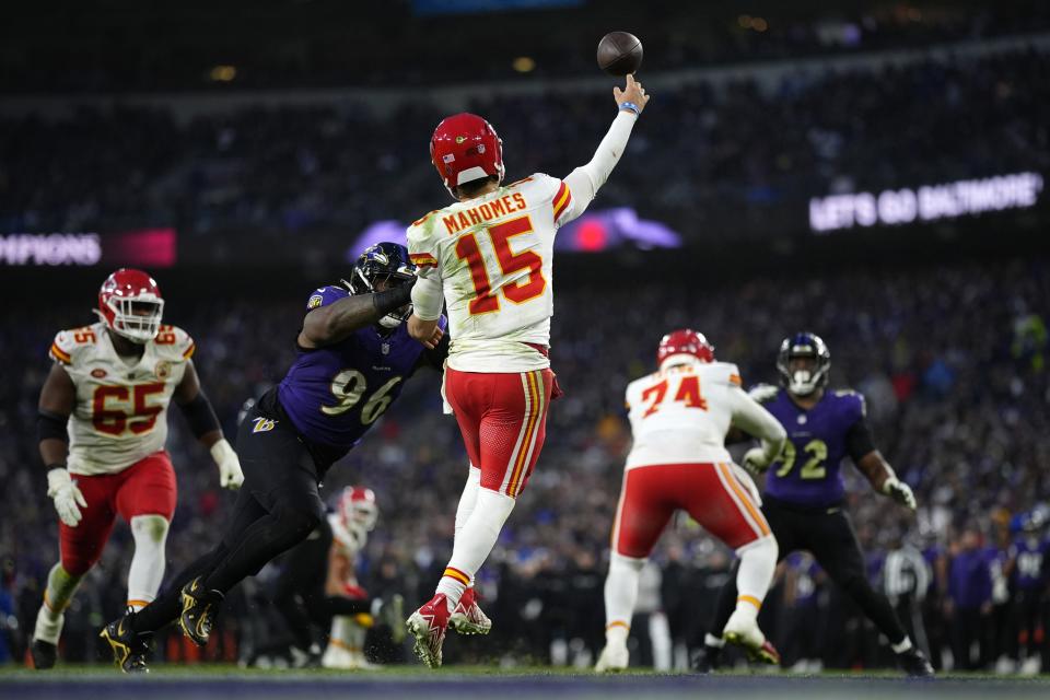 Kansas City Chiefs quarterback Patrick Mahomes (15) passes under pressure from Baltimore Ravens defensive tackle Broderick Washington (96) during the second half of the AFC Championship NFL football game, Sunday, Jan. 28, 2024, in Baltimore. (AP Photo/Matt Slocum)