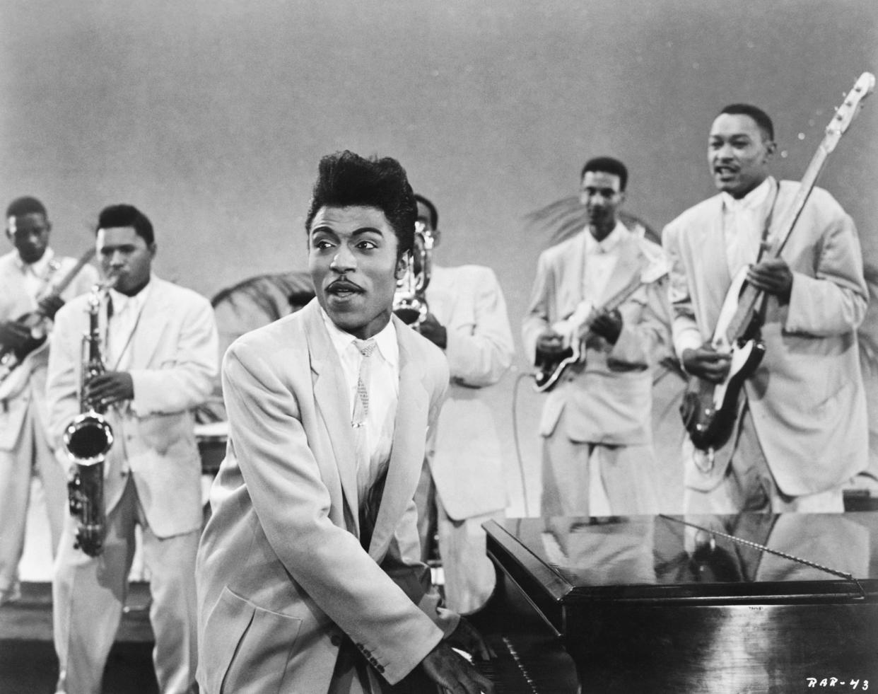 CIRCA 1957: Musician Little Richard performs onstage with his band as his saxophone player Grady Gaines stands on the piano in circa 1957 in scene from the movie 'Mister Rock And Roll.' (Photo by Michael Ochs Archives/Getty Images)