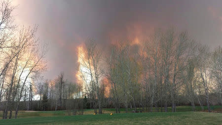 Wildfire is seen from MacDonald Island Park near Fort McMurray, Alberta May 3, 2016. Courtesy Kangen Lee/Handout via REUTERS