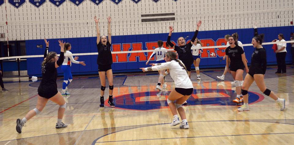 Smithsburg libero Sid Cecco, in white shirt, points to Skylar Horman, left, after Horman's ace led to her teammates celebrating during the second set of the Leopards' four-set victory over Boonsboro in the 1A West Region II volleyball semifinals at Boonsboro on Nov. 7, 2022.