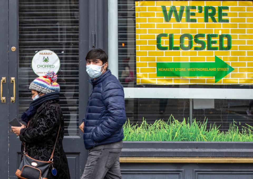 Pedestrians wearing PPE (personal protective equipment), of a face mask or covering as a precautionary measure against spreading COVID-19, in Dublin on October 19, 2020, amid reports that further lockdown restrictions could be imposed to help mitigate the spread of the novel coronavirus. - Ireland will crank up coronavirus restrictions, prime minister Micheal Martin said last week, announcing a raft of new curbs along the border with the British province of Northern Ireland. (Photo by PAUL FAITH / AFP) (Photo by PAUL FAITH/AFP via Getty Images)