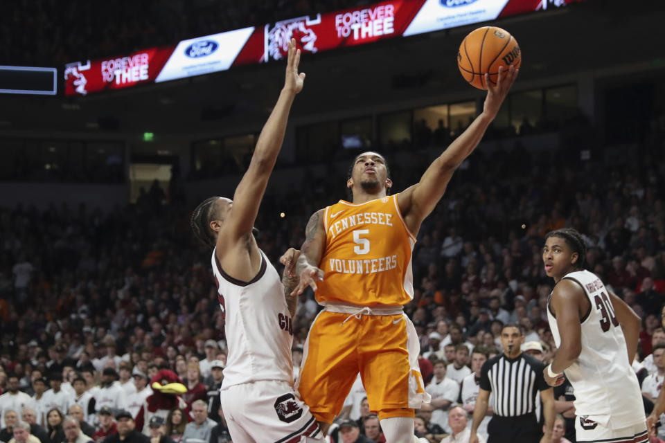 Tennessee guard Zakai Zeigler (5) shoots against South Carolina guard Ta'Lon Cooper, left, during the first half of an NCAA college basketball game Wednesday, March 6, 2024, in Columbia, S.C. (AP Photo/Artie Walker Jr.)
