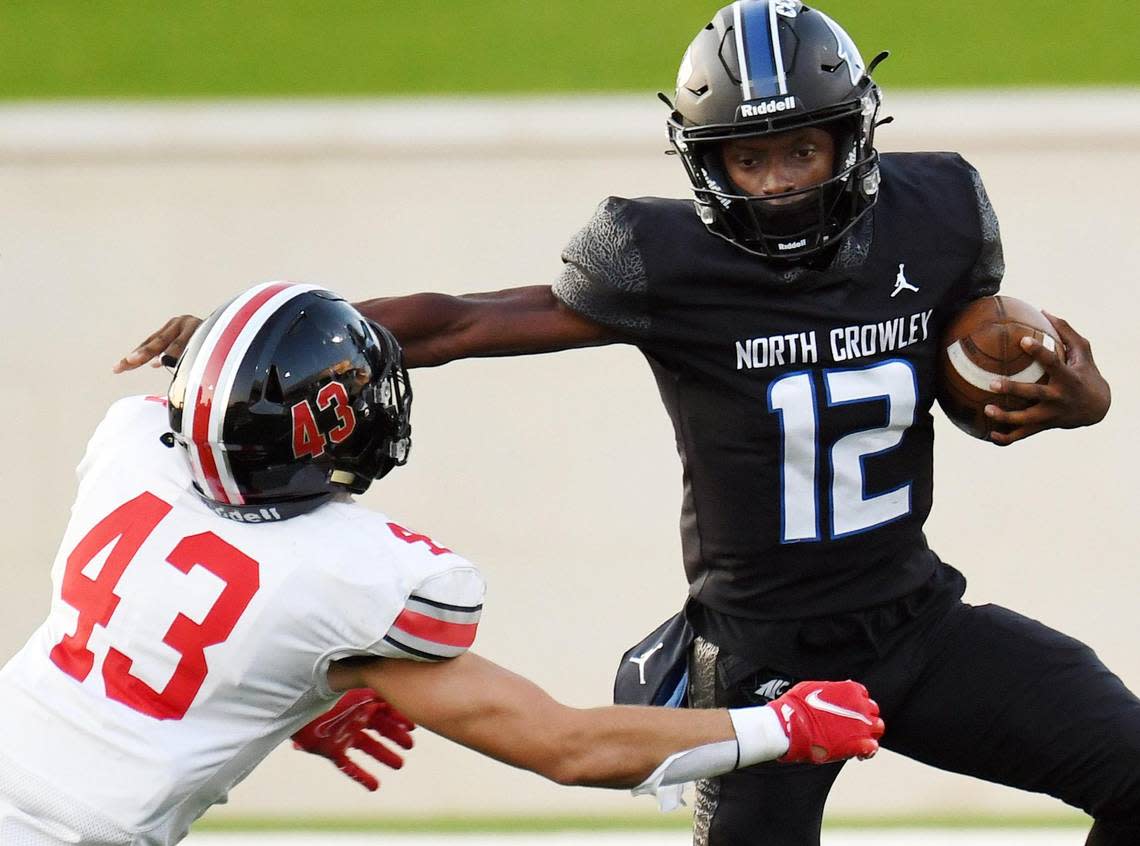 Lovejoy’s Chase Bogle, left is stiff-armed by North Crowley quarterback Chris Jimerson as he scrambles out of the backfield for extra yards in the first quarter of Thursday’s September 8, 2022 football game at Crowley ISD Stadium in Fort Worth, Texas. Special/Bob Haynes Bob Haynes/Special to the Star-Telegram