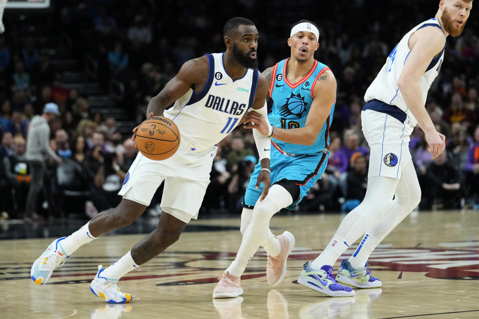 Dallas Mavericks forward Tim Hardaway Jr. (11) looks to pass as Phoenix Suns guard Damion Lee defends during the first half of an NBA basketball game, Thursday, Jan. 26, 2023, in Phoenix. (AP Photo/Matt York)