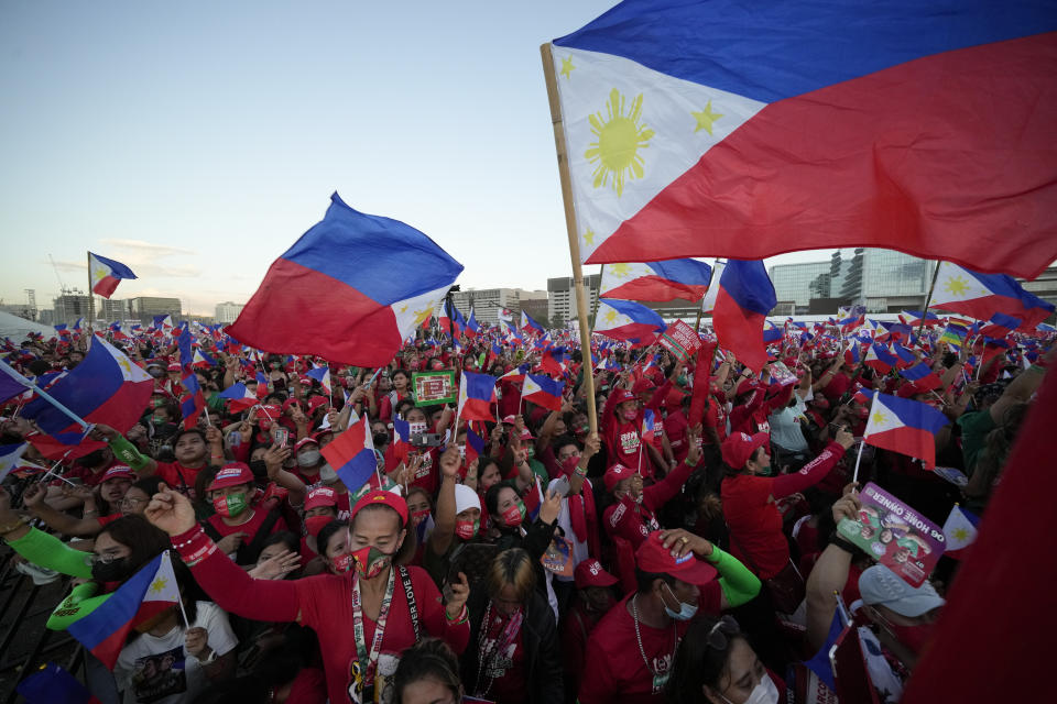 Supporters of presidential candidate, Ferdinand Marcos Jr., the son of the late dictator cheer as they wait for the last campaign rally known as "Miting De Avance" on May 7, 2022 in Paranaque city, Philippines. The winner of May 9, Monday's vote will inherit a sagging economy, poverty and deep divisions, as well as calls to prosecute outgoing leader Rodrigo Duterte for thousands of deaths as part of a crackdown on illegal drugs. (AP Photo/Aaron Favila)