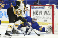 Buffalo Sabres goalie Dustin Tokarski (31) stops Boston Bruins forward Jake DeBrusk (74) during the second period of an NHL hockey game, Tuesday, April 20, 2021, in Buffalo, N.Y. (AP Photo/Jeffrey T. Barnes)