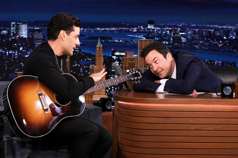 <p>Oscar Isaac plays guitar during an interview with host Jimmy Fallon on <em>The Tonight Show</em> on Oct. 15.</p>