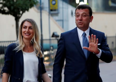 FILE PHOTO: Main opposition Republican People's Party (CHP) mayoral candidate Ekrem Imamoglu, accompanied by his wife Dilek Imamoglu, arrives for an event in Istanbul