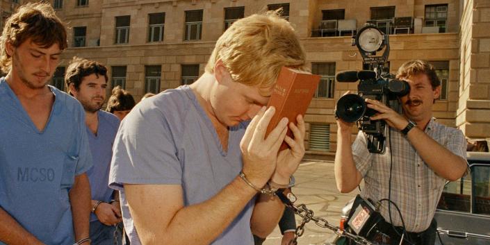Heber LeBaron covers his face with a bible while he and his half brother Douglas Barlow leave a preliminary extradition hearing in Phoenix, Ariz., Justice Court, July 18, 1988. The two men are the sons of polygamist sect leader, the late Ervil LeBaron. LeBaron and his Church of the Lamb of God are linked to slayings from Utah to Mexico.