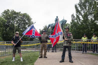 <p>Men hold confederate flags in front of a statue of Robert E. Lee at Emancipation park prior to the Unite the Right Rally on August 12, 2017 in Charlottesville, Virginia. (Photo: Jason Andrew/Getty Images) </p>