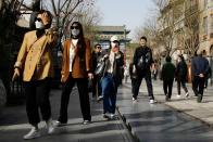 People walk at the tourism site of Qianmen street, in Beijing,