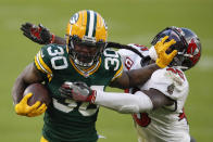 Green Bay Packers' Jamaal Williams pushes off Tampa Bay Buccaneers' Devin White during the second half of the NFC championship NFL football game in Green Bay, Wis., Sunday, Jan. 24, 2021. (AP Photo/Matt Ludtke)