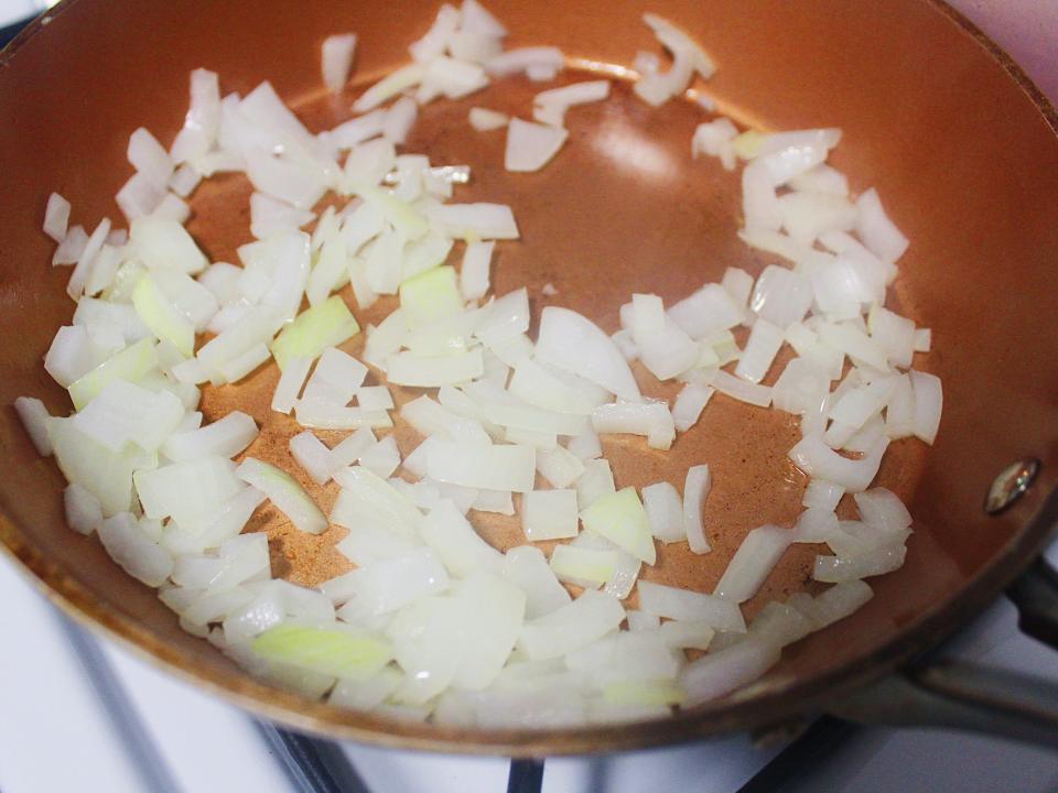 chopped white onions sauteed in pan