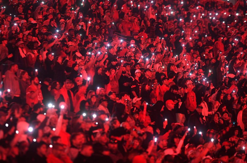 Texas Tech fans flash lights before the fourth quarter against UCF, Saturday, Nov. 18, 2023, at Jones AT&T Stadium.