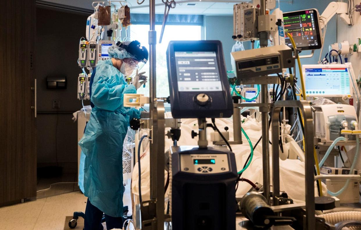 Nichole Arevalo, an R.N. at the downtown campus of NCH in Naples treats a COVID-19 patient in the Intensive Care Unit on Monday, August 9, 2021.  