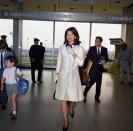 <p>Jackie Kennedy and John F. Kennedy Jr. walk through a Florida airport in the year 1966. </p>