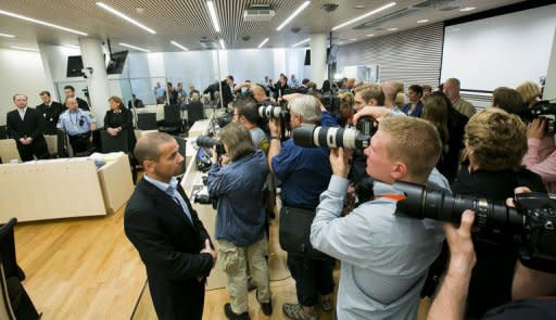 Photographers take pictures of right-wing extremist Anders Behring Breivik (back left) in the courtroom in Oslo on the last day of Breivik's trial on Friday. His defence sought to prove that Breivik's killing of 77 people in twin attacks in July 2011 was not an act of insanity