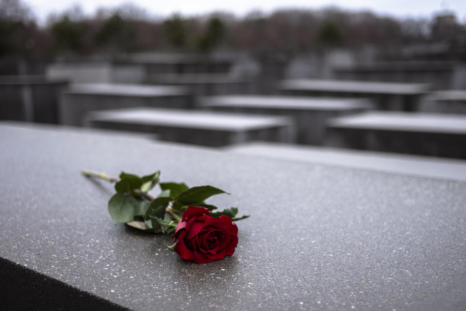 FILE - In this Jan.27, 2019 file photo a red rose lies on a slab of the Holocaust Memorial to commemorate the victims of the Nazis in Berlin. Germany has committed millions of dollars in extra funding to survivors of the Nazi Holocaust to help ensure that all of them are able to get vaccinated against the coronavirus, the organization that handles claims on behalf of Jewish victims said Wednesday. (AP Photo/Markus Schreiber,file)