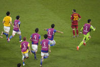 Spain's Dani Carvajal stands while Japan players celebrate after defeating Spain 2-1 during the World Cup group E soccer match between Japan and Spain, at the Khalifa International Stadium in Doha, Qatar, Thursday, Dec. 1, 2022. (AP Photo/Themba Hadebe)