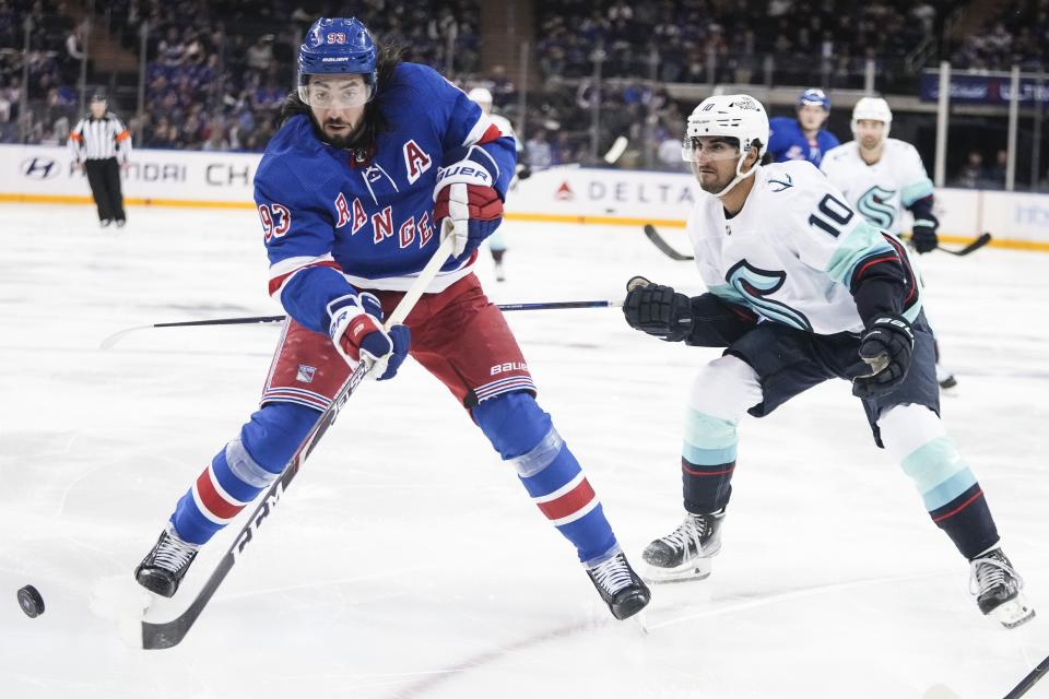 New York Rangers' Mika Zibanejad (93) works for the puck next to Seattle Kraken's Matty Beniers (10) during the second period of an NHL hockey game Friday, Feb. 10, 2023, in New York. (AP Photo/Frank Franklin II)