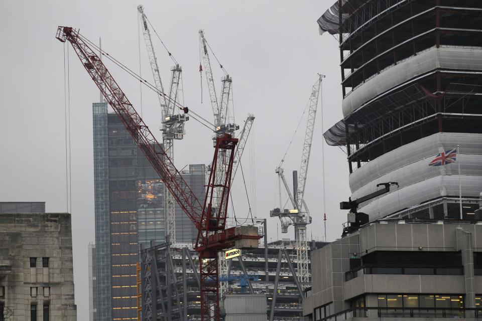 Construction cranes are seen in the City of London, Thursday, Oct. 25, 2012. Britain's economy grew by a bigger than expected 1 per cent between July and September, ending a shallow nine-month recession. The figure announced Thursday by the Office for National Statistics beat the market consensus forecast of 0.6 per cent growth. (AP Photo/Sang Tan)