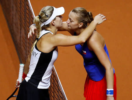 Tennis - Fed Cup - World Group Semi Final - Germany vs Czech Republic - Porsche Arena, Stuttgart, Germany - April 22, 2018 Czech Republic’s Petra Kvitova hugs Germany’s Angelique Kerber after winning their singles match to reach the Fed Cup Final REUTERS/Kai Pfaffenbach