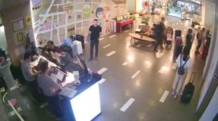 Cody Wilson, a Texan 3-D printed gun maker who flew to Taiwan as police investigated an accusation he had sex with an underage girl, stands in the lobby of Your Hotel in Taipei, Taiwan, September 20, 2018 in this still image from CCTV footage. Courtesy "Your Hotel"/via Reuters TV