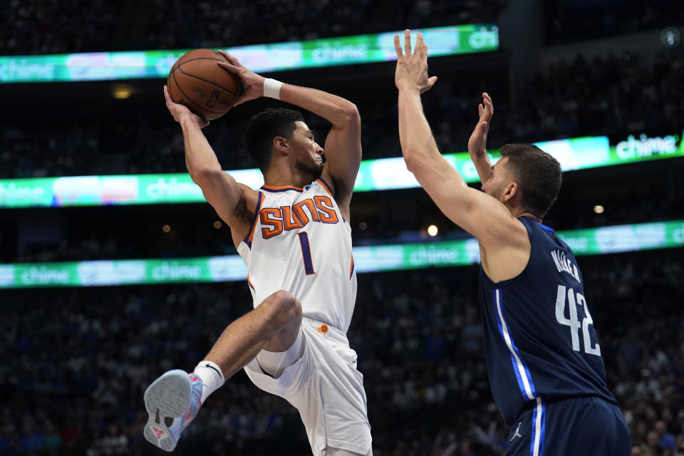 Phoenix Suns guard Devin Booker (1) drives to the basket against Dallas Mavericks forward Maxi Kleber (42) during the first half of Game 6 of an NBA basketball second-round playoff series, Thursday, May 12, 2022, in Dallas. (AP Photo/Tony Gutierrez)