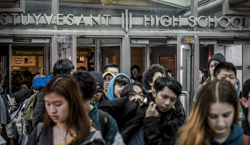 FILE - In this March 13, 2020, file photo, students at Stuyvesant High School leave after classes in New York. Most New York City students will return to their physical schools two or three days a week and learn online the rest of the time under a plan announced Wednesday, July 8, 2020, by Mayor Bill de Blasio, who said schools can't accommodate all their students at any one time and maintain safe social distancing. (AP Photo/Bebeto Matthews, File)