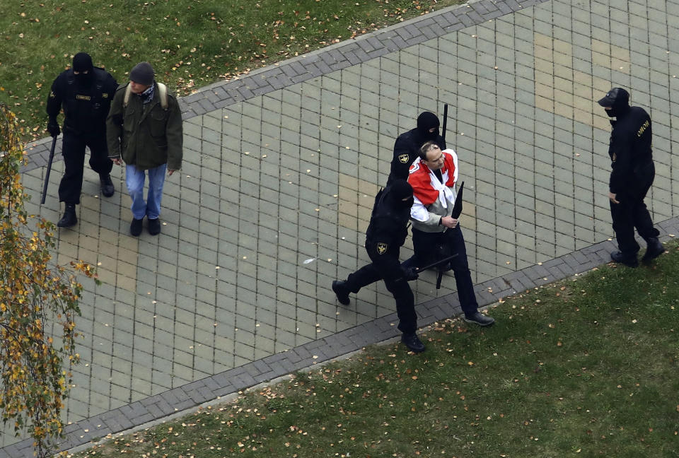 Belarus policemen detain men during an opposition rally to protest the official presidential election results in Minsk, Belarus, Sunday, Oct. 11, 2020. Hundreds of thousands of Belarusians have been protesting daily since the Aug. 9 presidential election. (AP Photo)