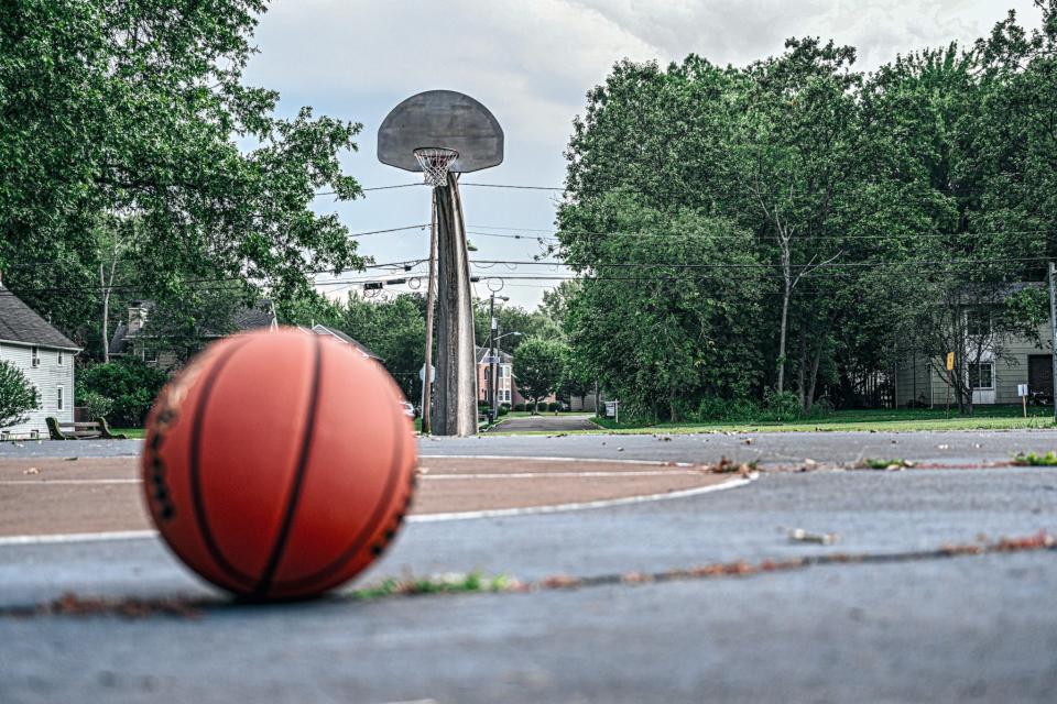 Grass grows through the cracks of the basketball court at David and Phillip Miller Park in Bridgewater's Hobbstown section.